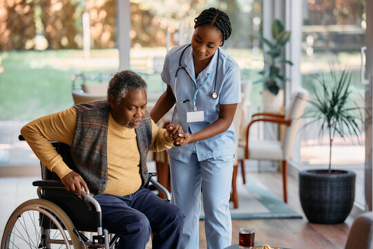 Nurse providing compassionate care to patient in wheelchair at home
